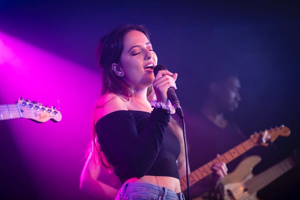 Female singing at microphone