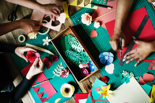 Hands busy making props and decorations for a show