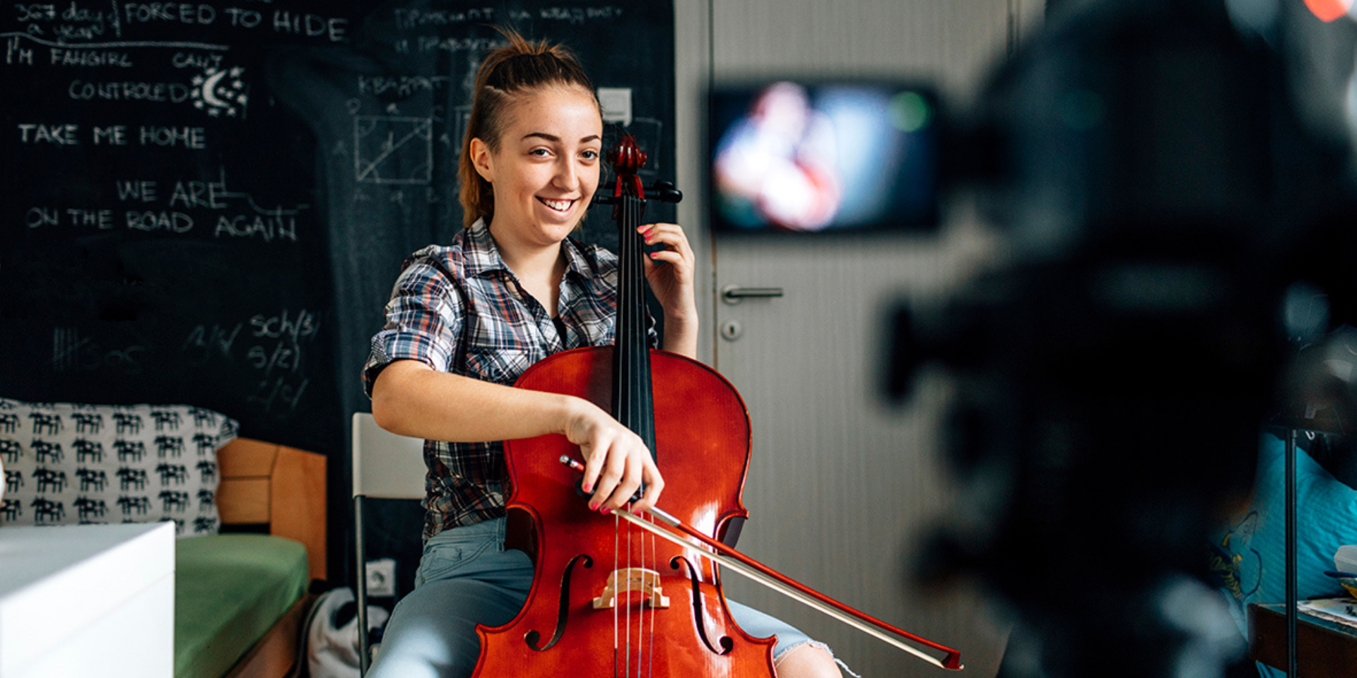 Girl playing cello facing a video camera