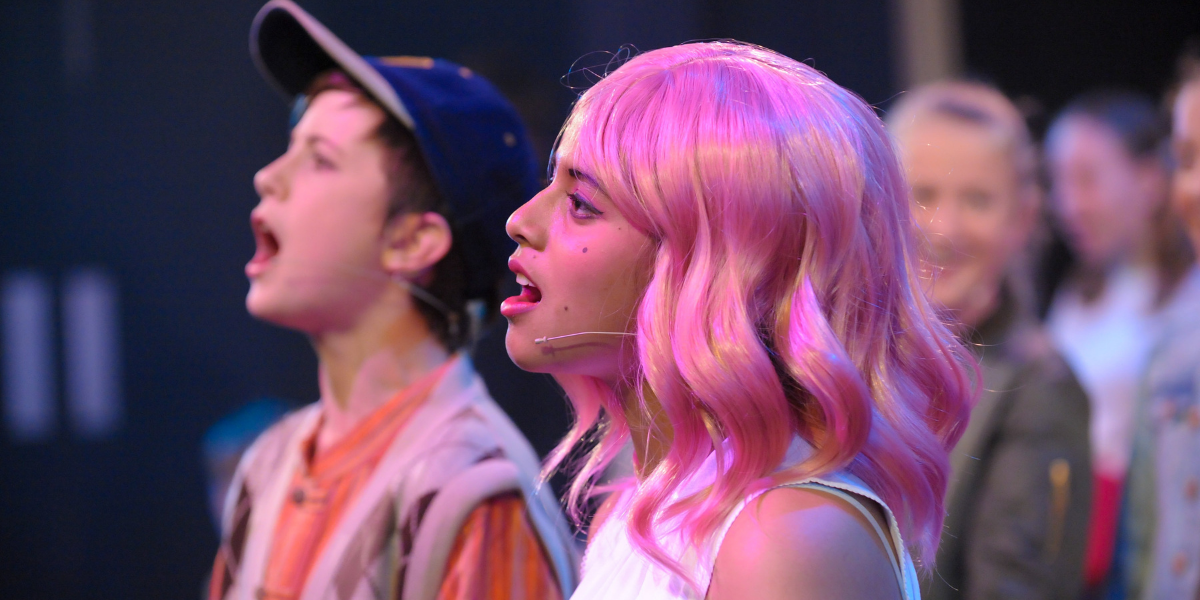 Boy and girl singing on stage